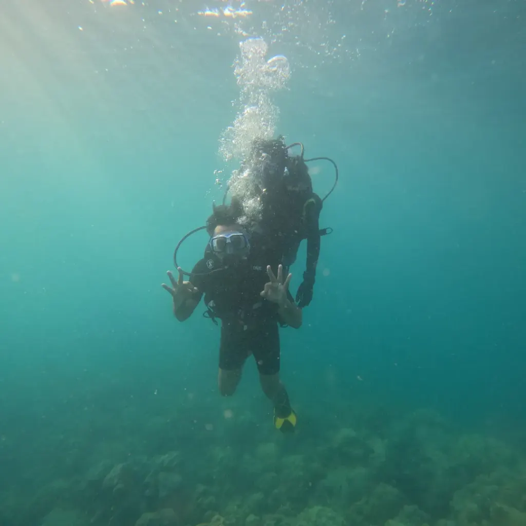 Diver descending with bubbles rising above, RAID Advanced 35 course in Havelock, Andaman