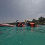 Snorkellers at the float ring with the shore behind, snorkelling in Havelock Island
