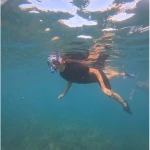 Snorkeller in a mask swimming over the reef, snorkelling in Havelock Island