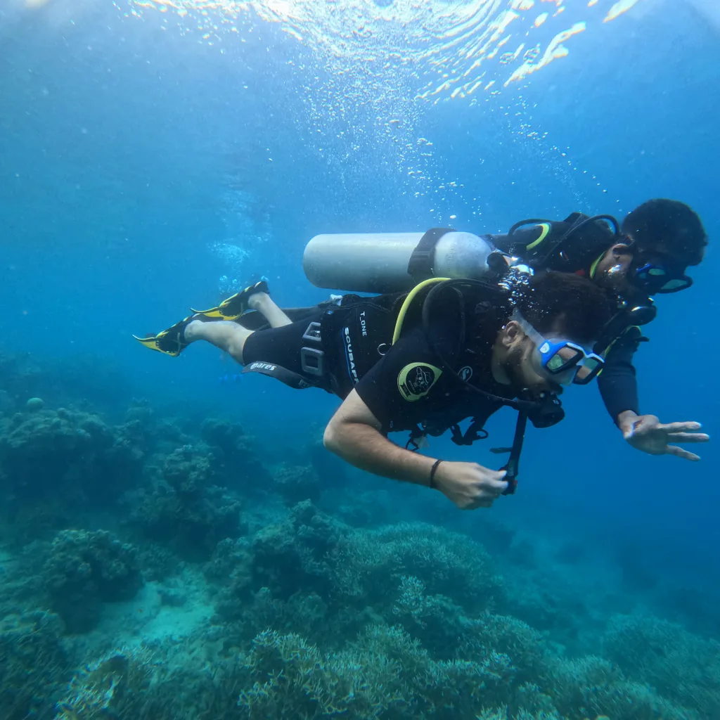 Diver finning over the reef during boat diving in Andaman