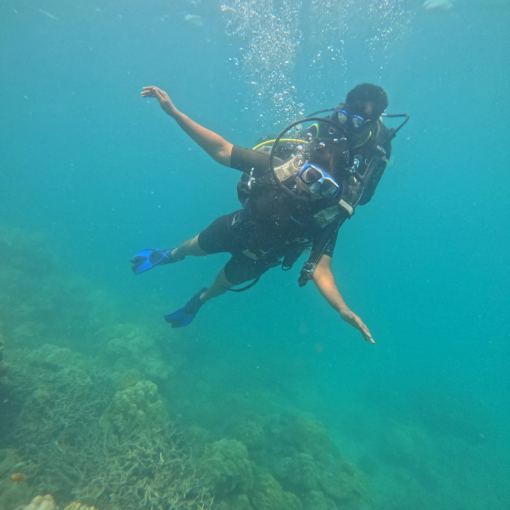 Instructor guiding a first-time diver, boat scuba diving in Havelock
