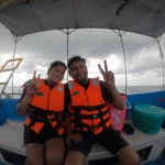 Couple in orange life jackets on the boat, a boat day trip from Havelock