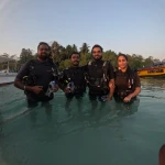 Group of divers standing in the sea in the evening, RAID Divemaster course in Havelock, Andaman
