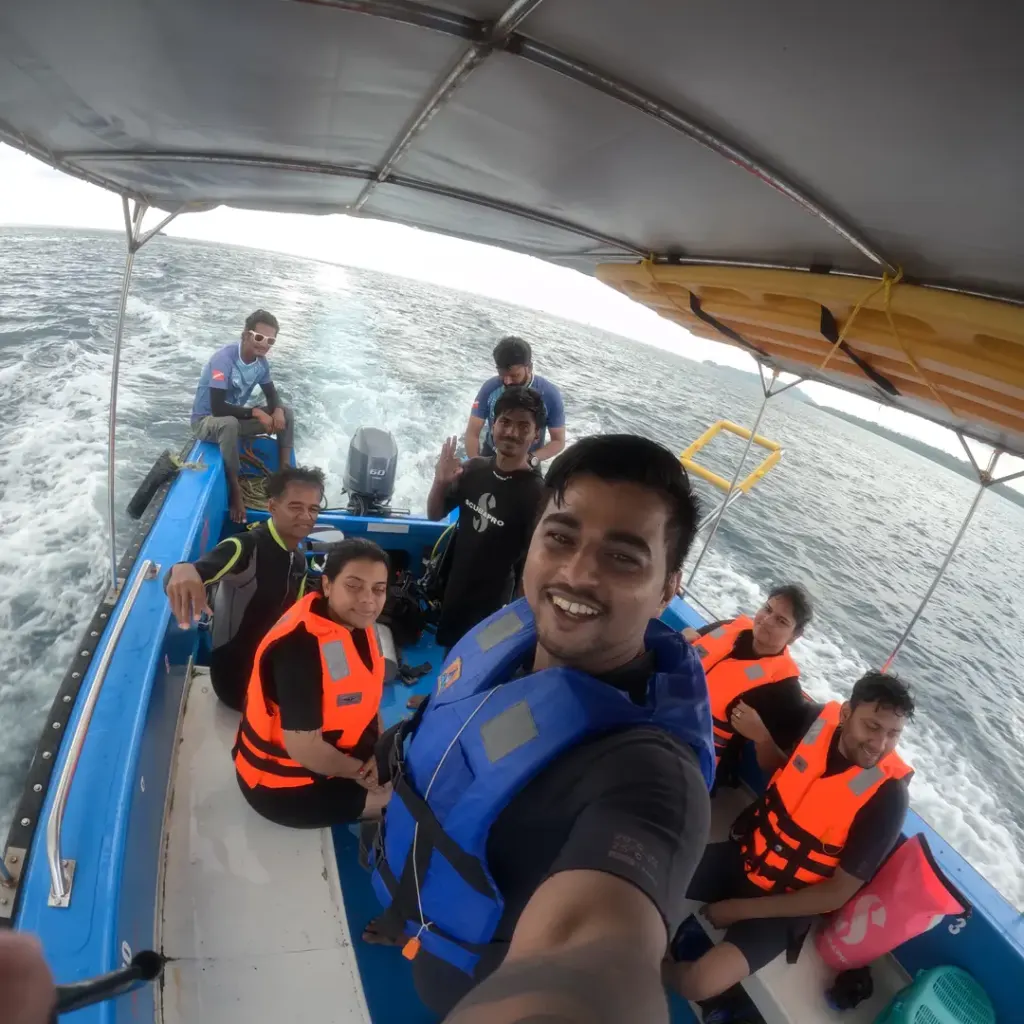 Group in life jackets on the boat taking a selfie, RAID Divemaster course in Havelock, Andaman