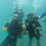 Group of three divers under water, RAID Divemaster course in Havelock, Andaman