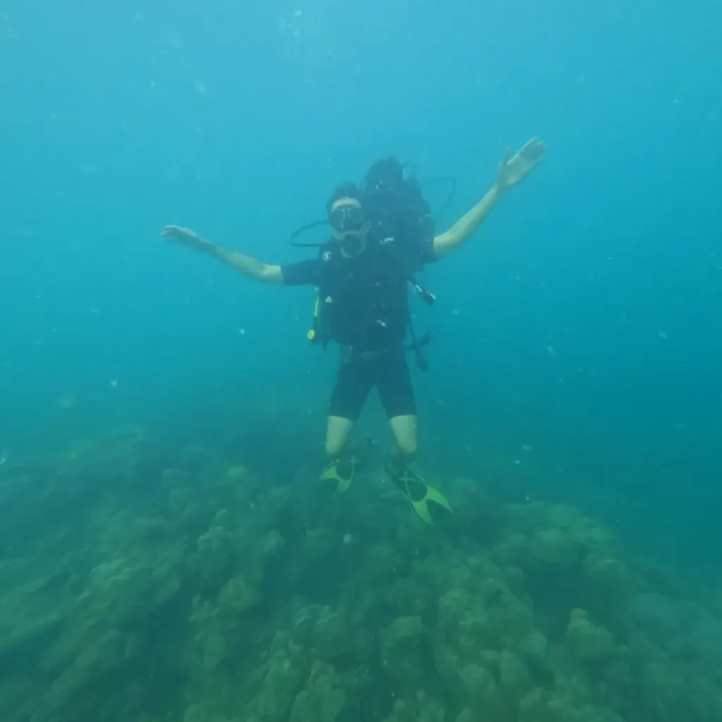Diver with arms spread above the reef, fun diving in Havelock Island