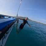 Diver climbing the boat ladder in open water, fun diving in Havelock Island