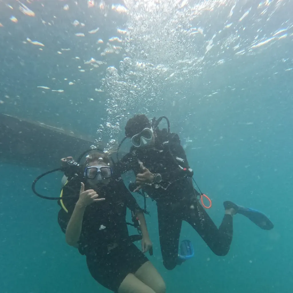 Two divers swimming down together, fun diving in Havelock Island