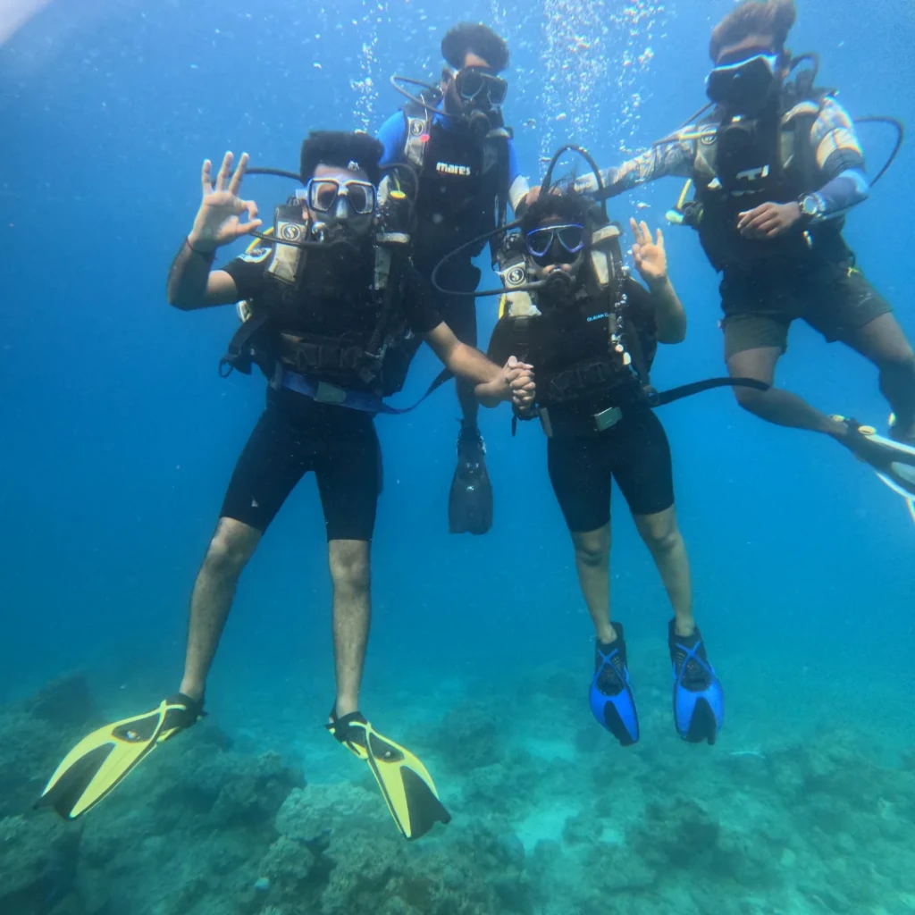 Group shore scuba diving in Havelock - four divers together on the shallow reef