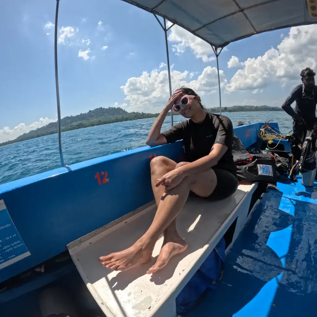 Guest sitting on the boat with an island in view, island hopping from Havelock