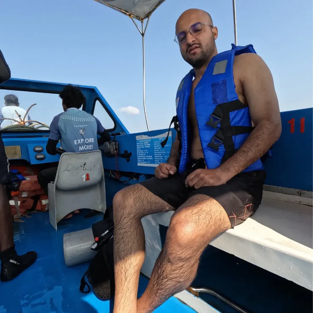 Guest in a life jacket on the boat, snorkelling in Havelock Island