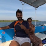 Couple sitting on the blue boat under the canopy on the way to a snorkelling reef in Havelock
