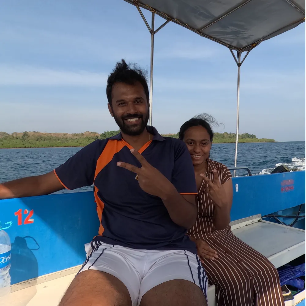 Couple sitting on the blue boat under the canopy on the way to a snorkelling reef in Havelock