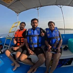 Three guests in life jackets on the boat, island hopping in Andaman