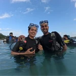 Couple standing in the sea in full scuba gear before the dive, Juvi's scuba diving, Havelock Island