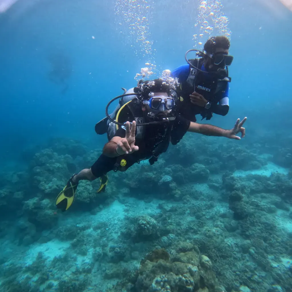 Diver and instructor gliding together over the reef, Lighthouse scuba diving, Havelock Island