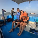 Couple in life jackets on the boat with the crew, a boat day trip from Havelock