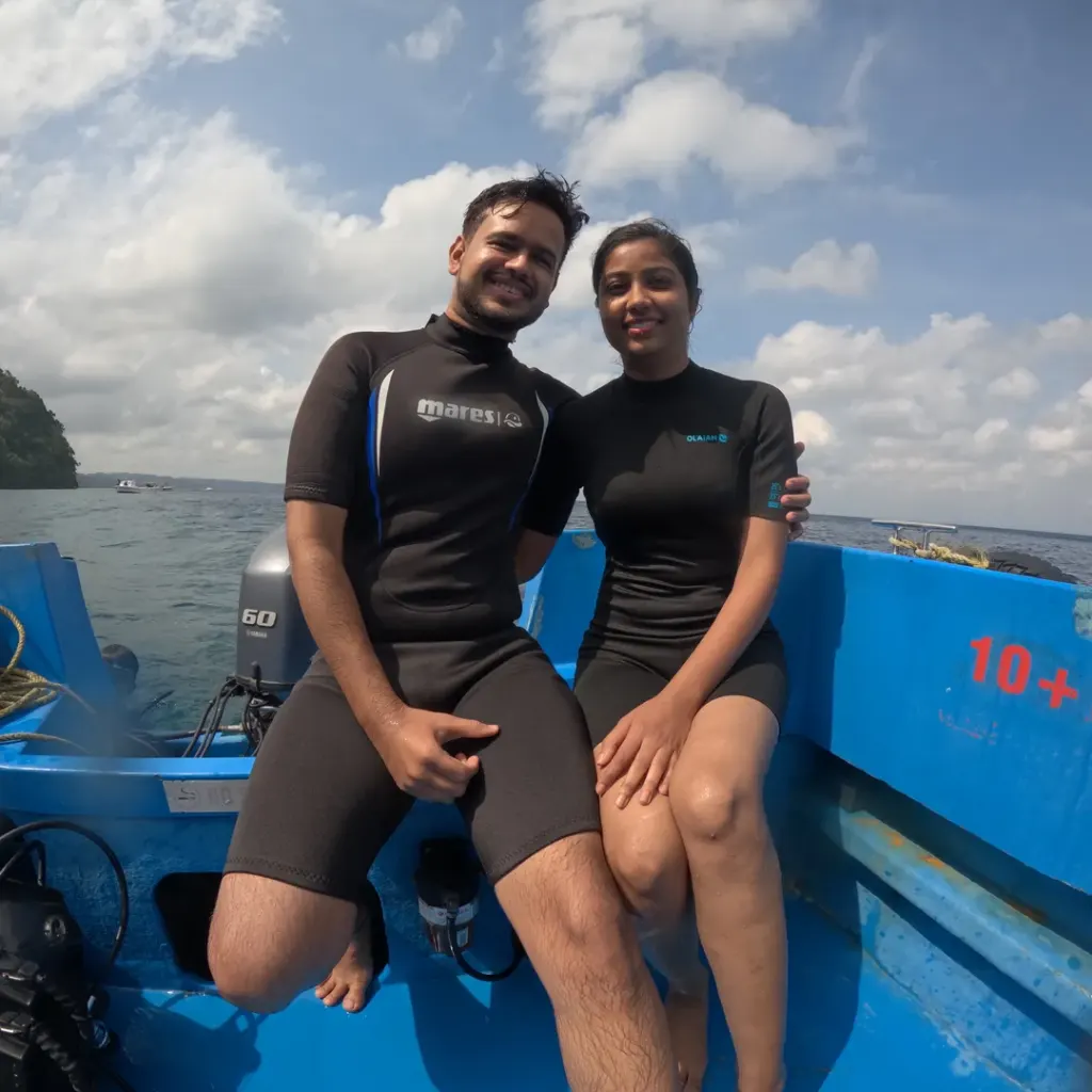 Couple sitting at the back of the boat by the engine, a boat day trip from Havelock