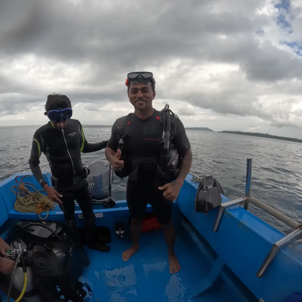Two people in wetsuits standing on the dive boat, Nitrox course in Havelock, Andaman