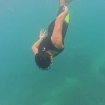 Snorkeller diving down head first, snorkelling in Havelock Island