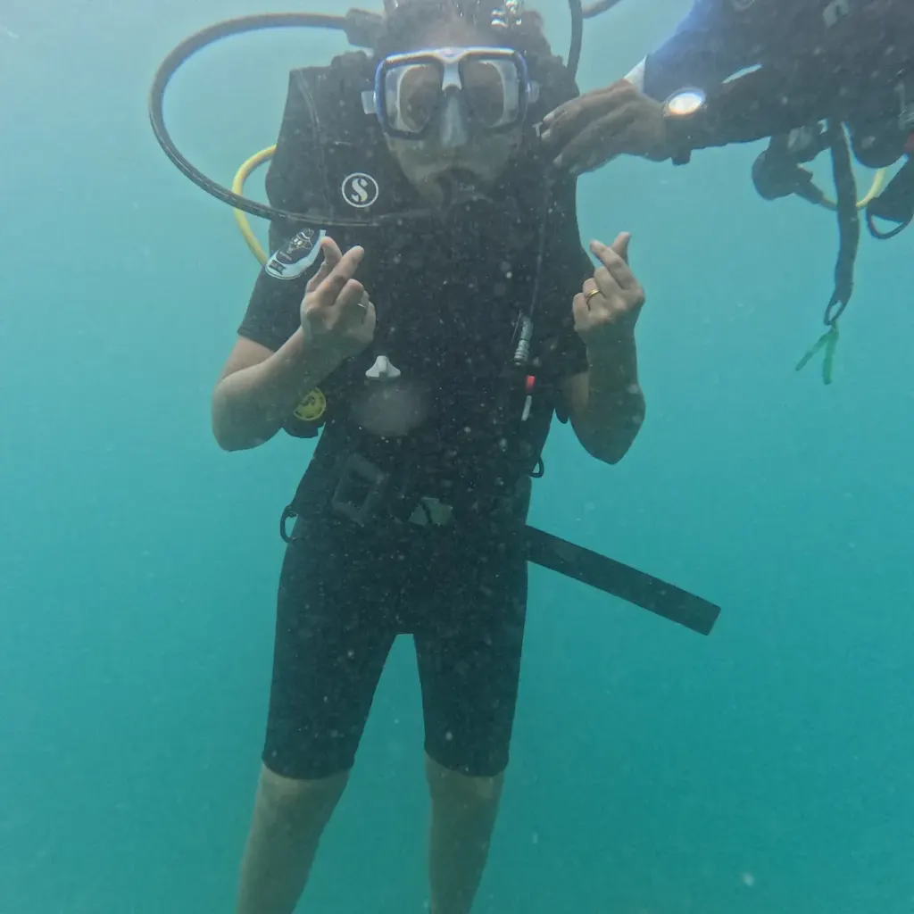 Diver making hand signs in blue-green water, RAID Advanced 35 course in Havelock, Andaman