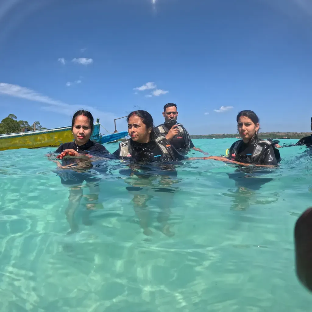 Group of guests in scuba gear in shallow water, RAID Divemaster course in Havelock, Andaman