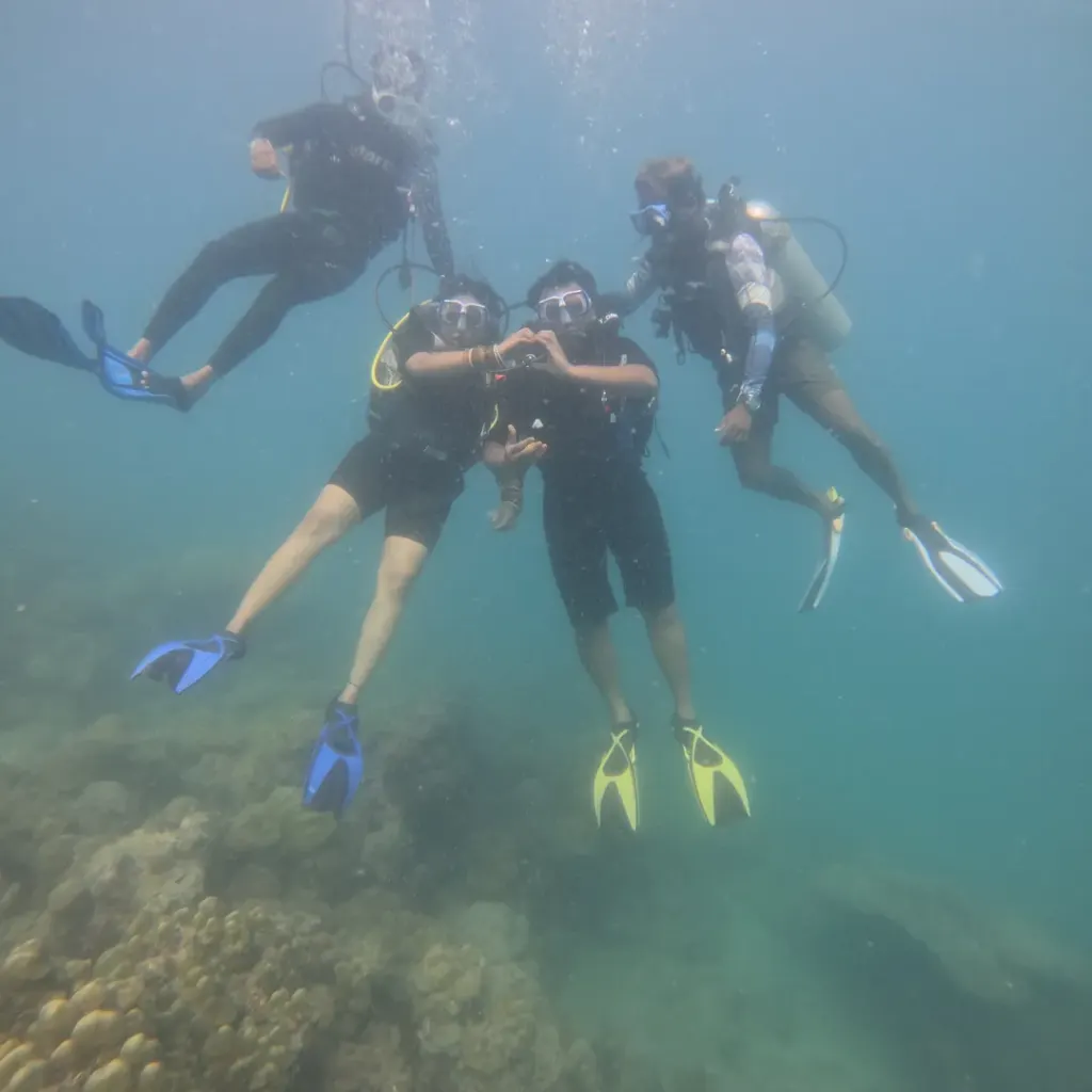 Group of four divers under water, RAID Open Water course in Havelock, Andaman