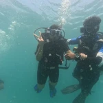 Two divers making hand signs, RAID Open Water course in Havelock, Andaman