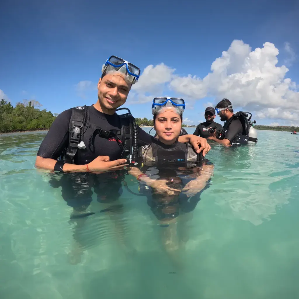 Two divers in scuba gear standing in shallow water, RAID Open Water course in Havelock, Andaman