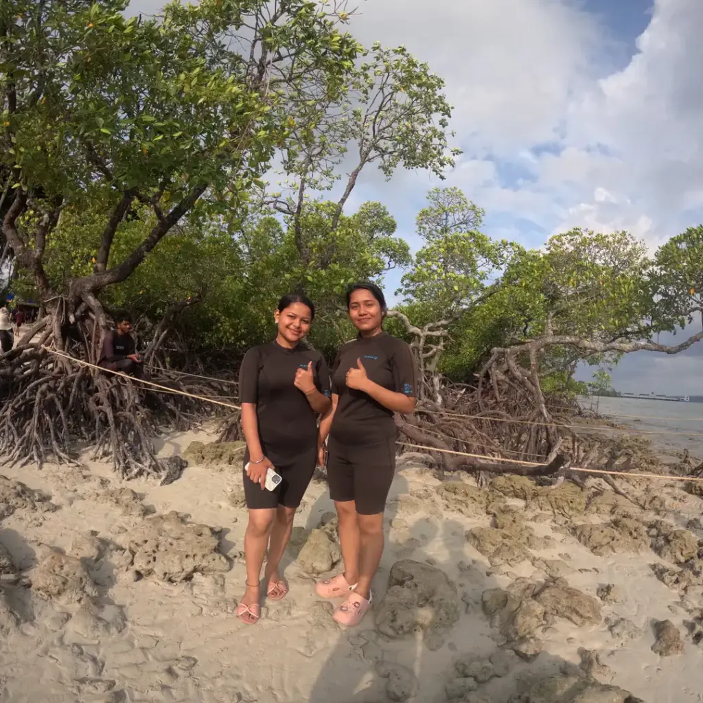 Two friends on a beach with mangrove trees, island hopping from Havelock