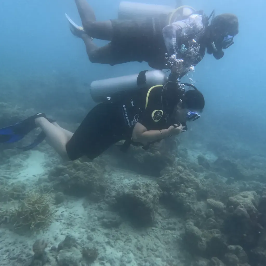 Two divers swimming over the reef, RAID Open Water course in Havelock, Andaman