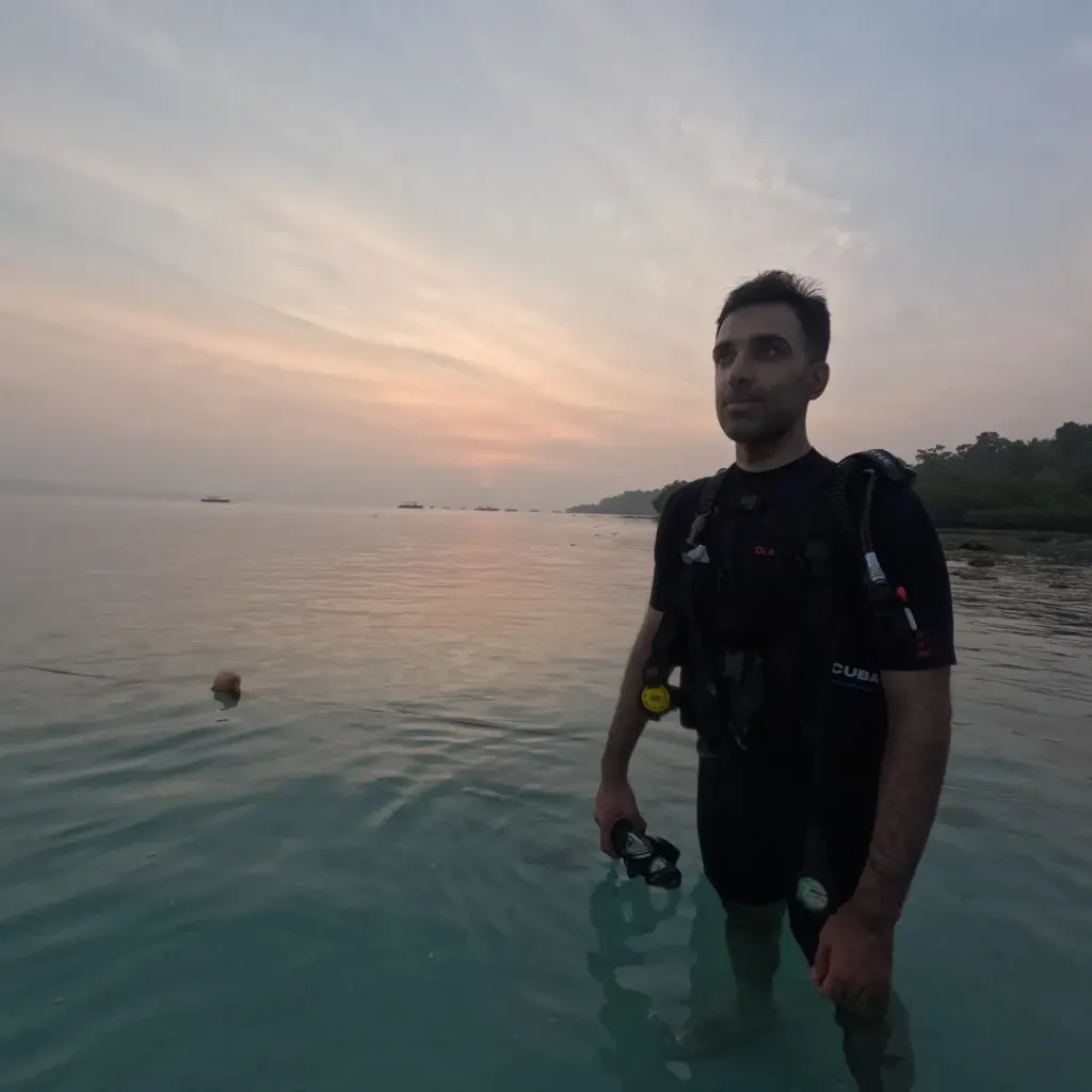 Guest in scuba gear standing in calm water at sunset, Try Scuba diving in Havelock Island