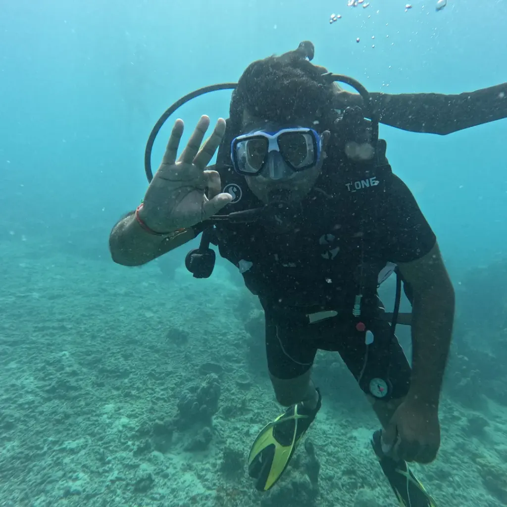 Diver making a hand sign close to the camera, scuba refresher in Havelock Island