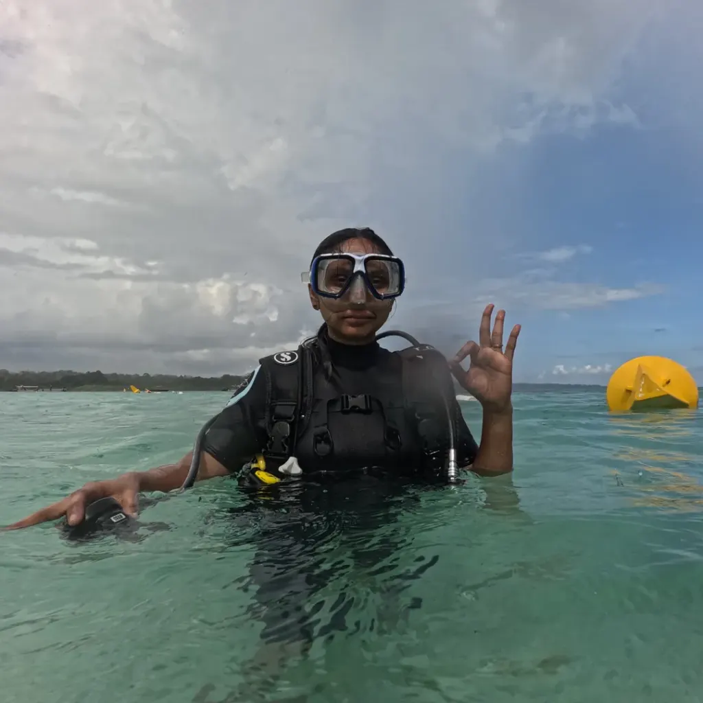 Diver in scuba gear in shallow water with a buoy, scuba refresher in Havelock Island