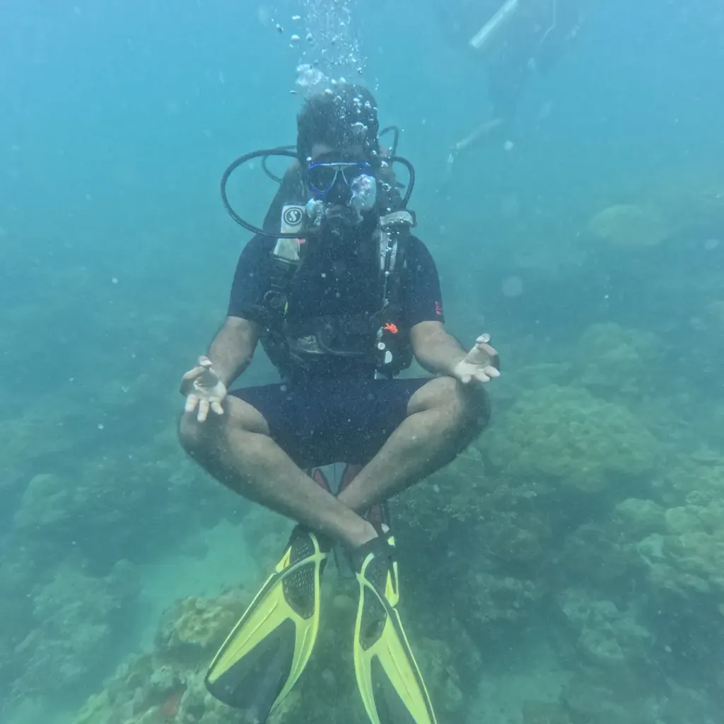 Diver hovering cross-legged above the reef, scuba refresher in Havelock Island