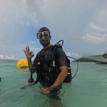 Diver in scuba gear making an OK sign in shallow water, scuba refresher in Havelock Island