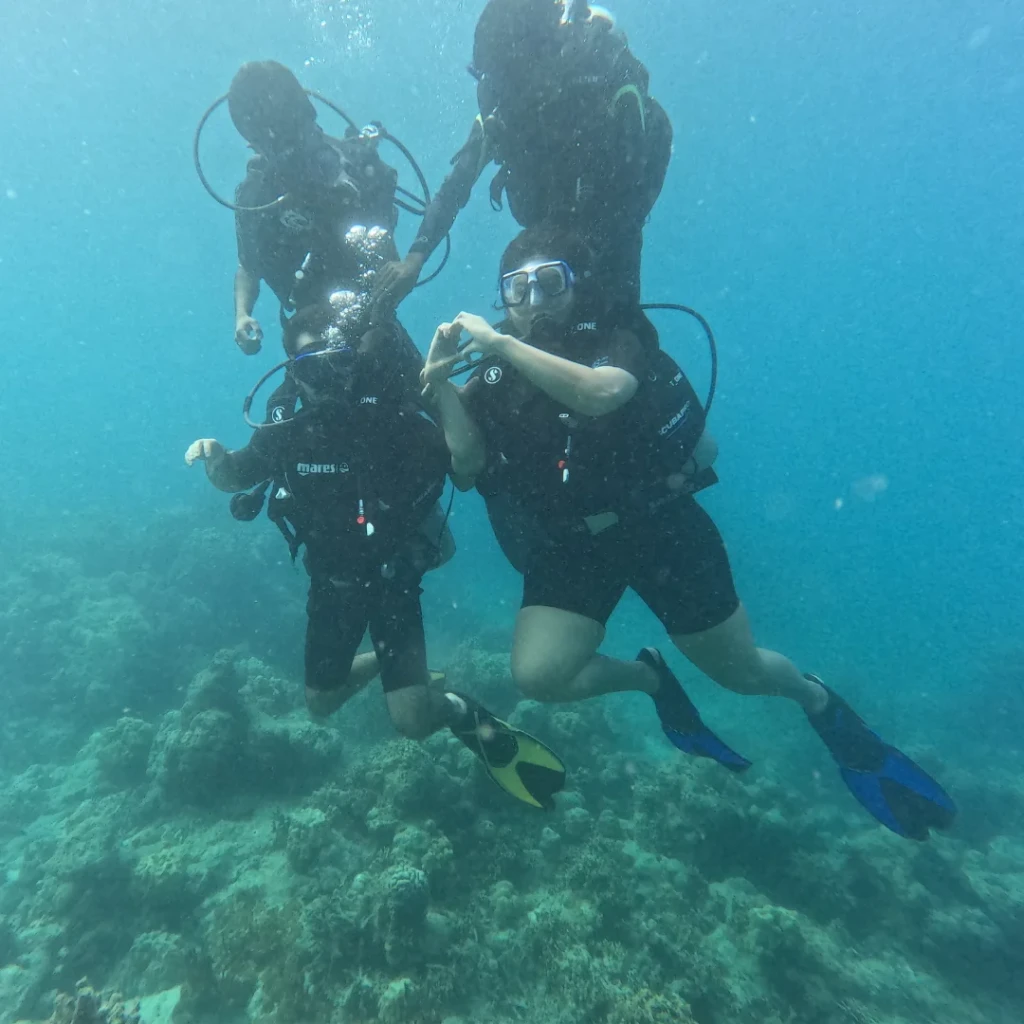 Shore dive in Andaman - instructor guiding a first-time diver underwater