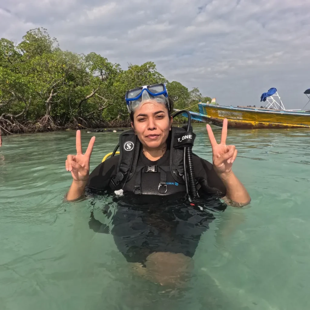 Shore diving in Havelock - diver in full scuba gear standing in waist-deep water