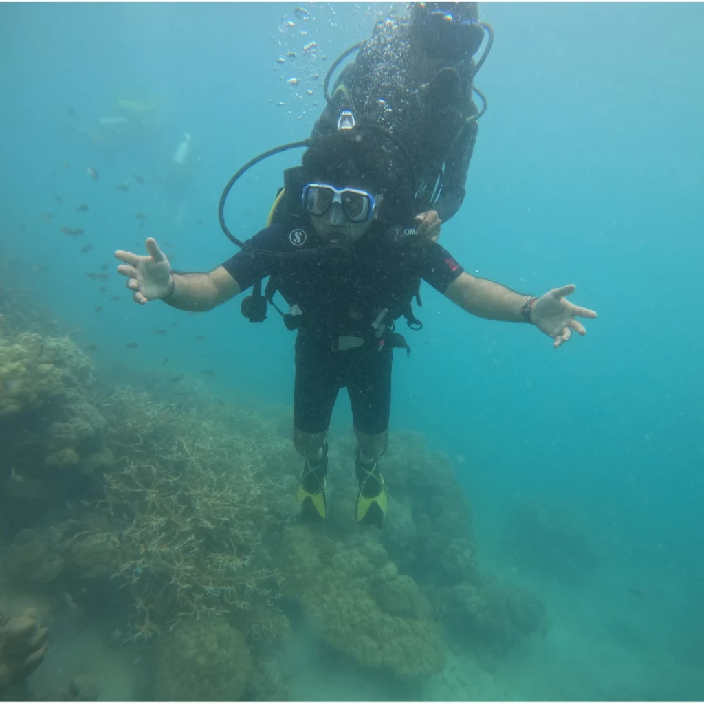 Shore scuba diving in Andaman for beginners - diver floating above the reef