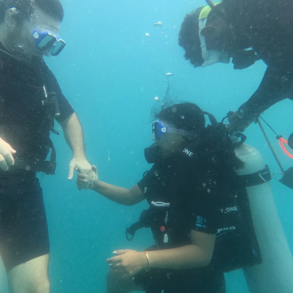 Shore scuba diving in Havelock for non swimmers - instructor holding the diver's hand