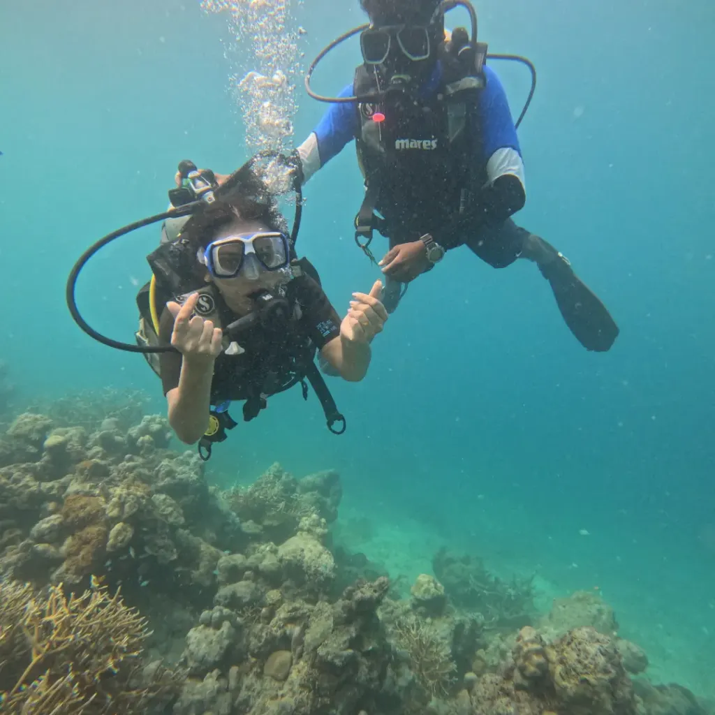 Diver making a hand sign with the instructor beside, The Slope scuba diving, Havelock Island