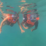 Two snorkellers in life jackets floating face down, a boat trip from Havelock