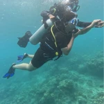 Diver with the instructor holding the tank over the reef, The Slope scuba diving, Havelock Island