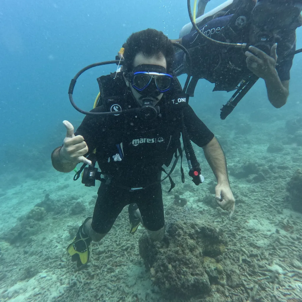 Guest giving a thumbs up beside the instructor while scuba diving at Tribe Gate, Havelock