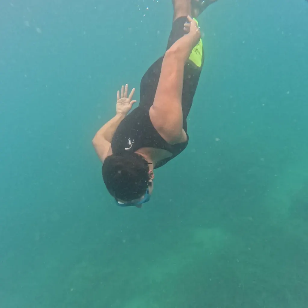Snorkeller diving down head first, snorkelling in Havelock Island