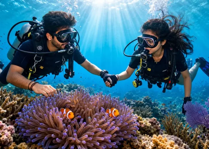 Honeymoon couple scuba diving together over a coral reef in Havelock, Andaman