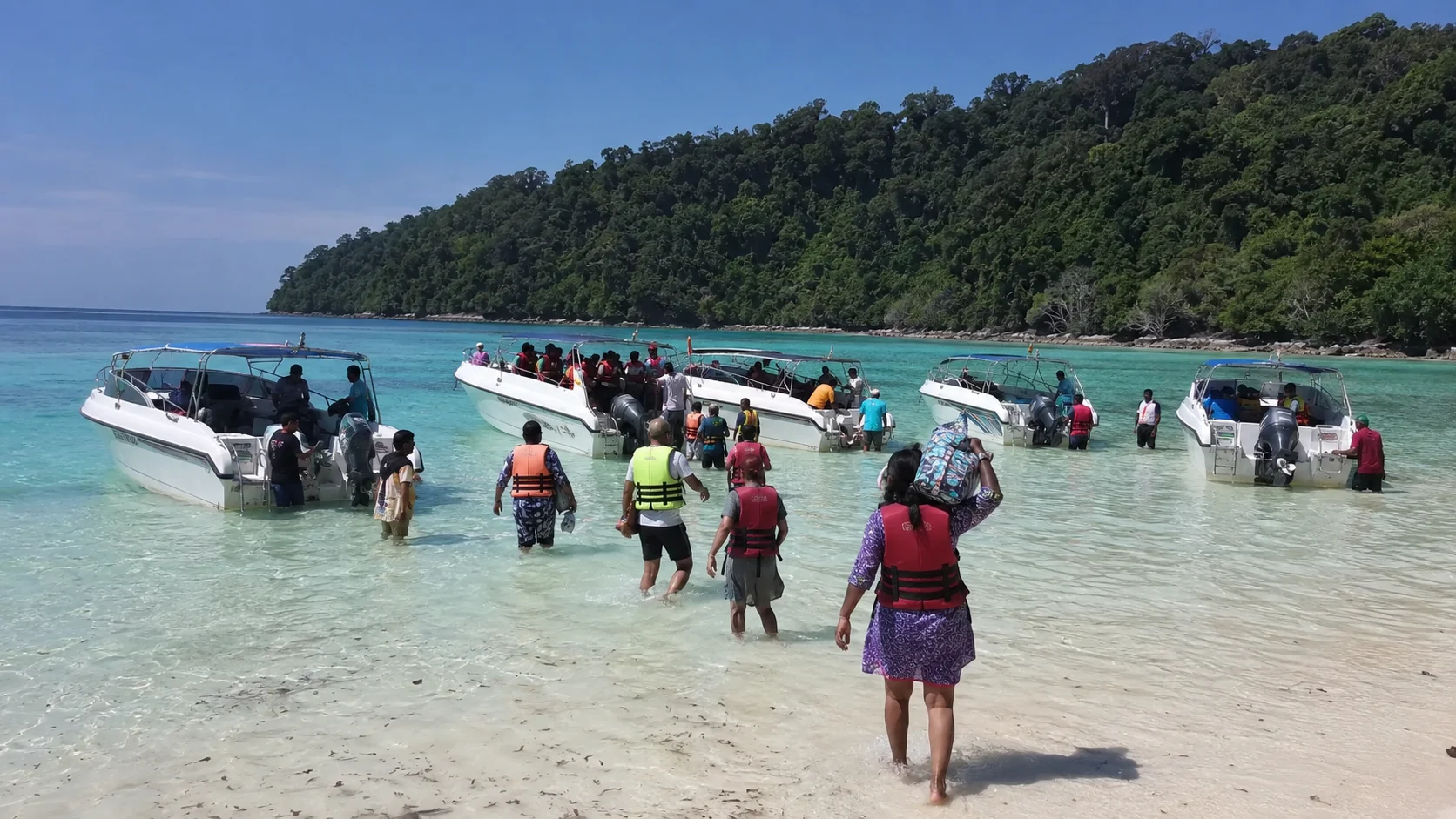 Speedboats dropping visitors in the shallows at Elephant Beach, Havelock