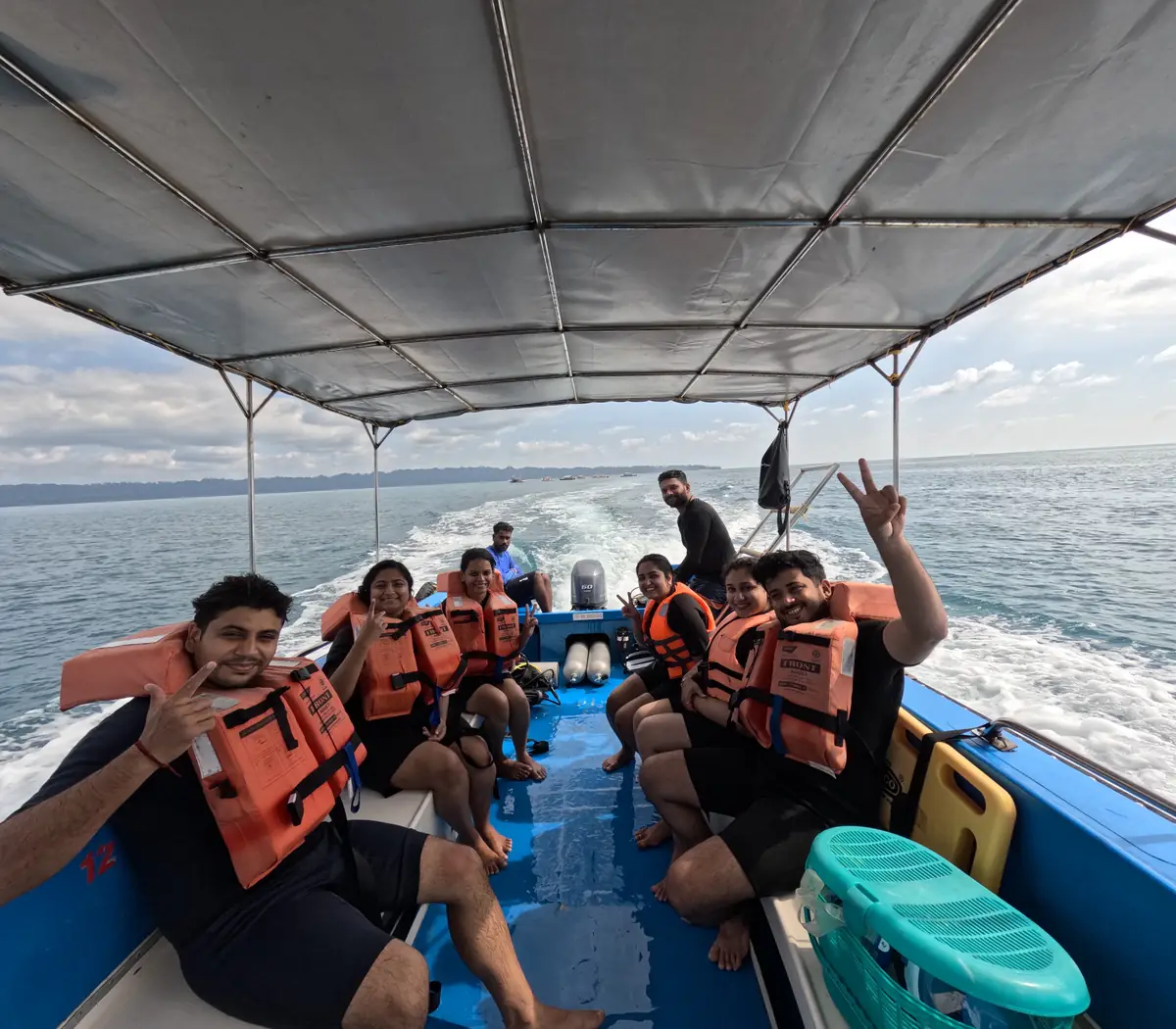 Beginners in life jackets on the dive boat heading out from Havelock Island, Andaman