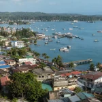 Port Blair harbour and town seen from a hillside, boats at anchor with green hills behind, Andaman Islands