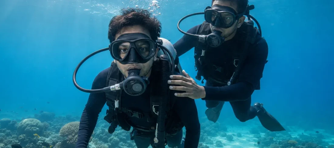 First-time scuba diver with instructor on a beginner dive at Havelock Island, Andaman